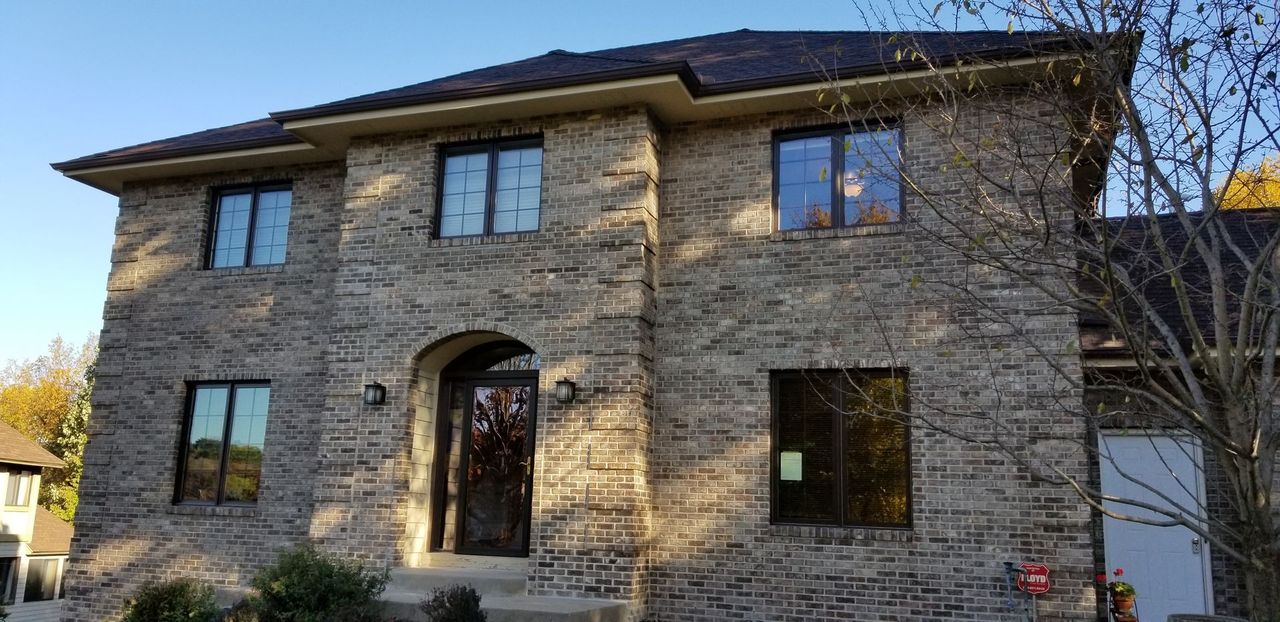 Two-story brick home with a new roof and windows